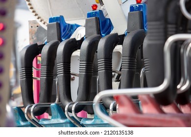 A View Of Amusement Park Thrill Ride Safety Harness System Seating.