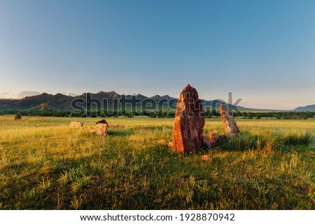 View of the ancient burial mounds and menhirs in the steppes and mountains of Khakassia near Kazanovka