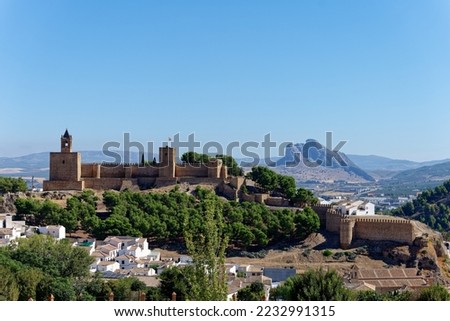 View of Antequera castle with the natural monument The Lovers Rock in the background. Touristic travel to Spain. Historic interest and Unesco World Heritage Site. 