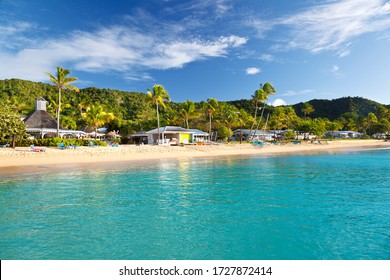 View to an Antiguan beach and hotel from a boat.