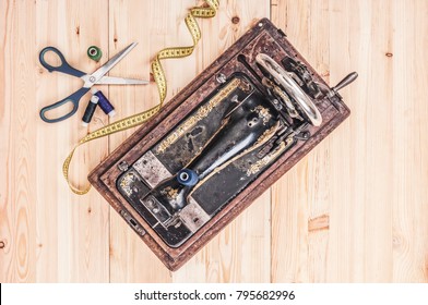 Up view at antique sewing machine on wooden background