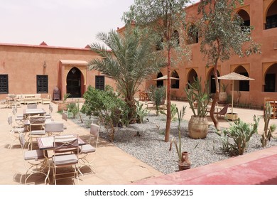 View Of Arabic Riad House Building With Traditional Islamic Ornaments And Decorations, Tables And Chairs In Urban Courtyard Garden In Oriental Town Medina Of Marrakesh, Morocco, Africa. May 20, 2018.