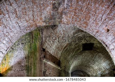 View of arches and brickwork of the space under the Bastion of San Paolino, part of the ancient Renaissance walls of Lucca, now restored and open to the public