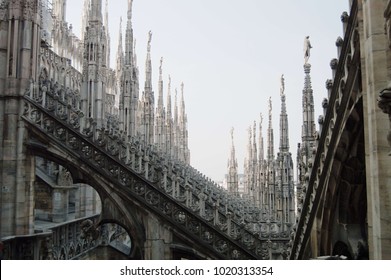 View of architectural detail of Duomo di Milano roofs. Foogy morning. Gloomy gothic