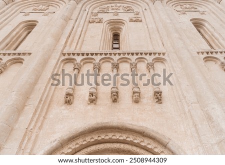 View of the architectural element of the blind arcade on the facade of ancient white stone Church of the Intercession on the Nerl. Temple in the Vladimir region of Russia, built in the 12th century.