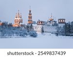 View of the architectural ensemble of the Novodevichy convent on a winter evening. Moscow, Russia