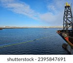 View of the Arctic community of Iqaluit, Nunavut from the marine infrastructure deep sea port with a shipped moored to the dock.