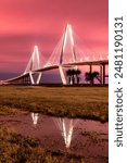 View of the Arthur Ravenel Bridge reflecting in water in Charleston South Carolina