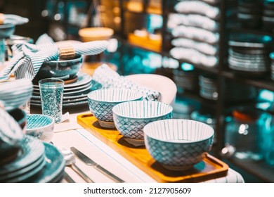 View of assortment of decor for interior shop in store of shopping center. Home accessories and household products for dining room in store of shopping centre. View of beautiful dinnerware on table