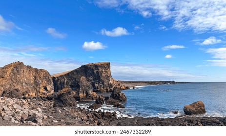 View of the Atlantic Ocean from the rocky coastline of Iceland. Photos of Iceland landscapes, beautiful clouds and calm ocean in spring. - Powered by Shutterstock