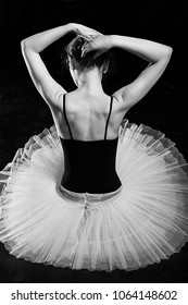 View Of The Back Of A Ballerina Wearing A Skirted Black Leotard And Ballet Tutu