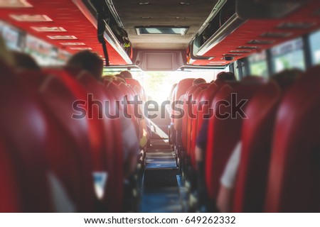 View from back seat in a bus. People sitting in a coach. Public transportation concept with summer vibe.