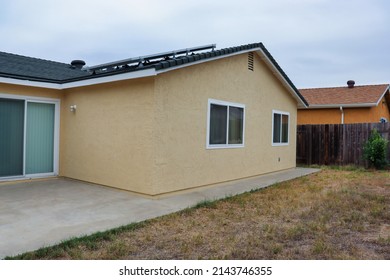 View Of The Back Side Of A Stucco House Freshly Painted.