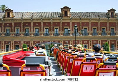 View from back of top deck on open roofed tour bus in Seville, Spain