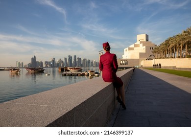 View from the back at unrecognisable cabin crew of Qatar Airways, looking at the Museum of Islamic Art and Doha sky view