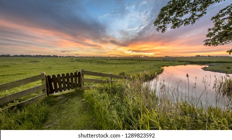 View from backyard of farm over agricultural landscape of dutch countryside in Groningen Netherlands