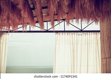 The view in to the balcony of rooftop background the ocean. House of the sea. wind blow the curtain