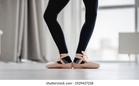 View of ballerina legs staying in first position during dance class in choreography studio