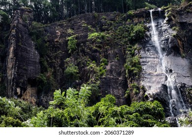 A View Of The Bambarakanda Waterfall And Large Rock Wall.