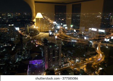 View Of Bangkok City Seen From Inside A Hotel Room At Night