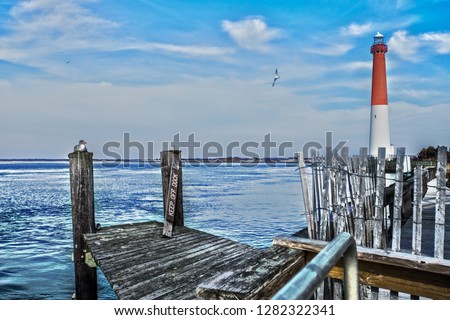 View of Barnegat light from the docks at Barnegat Bay a small brackish arm of the Atlantic Ocean, approximately 42 miles long, along the coast of Ocean County, New Jersey in the United States. 