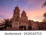 View of the baroque facade of the Jerónimos Monastery in Murcia, Spain on a pink dawn