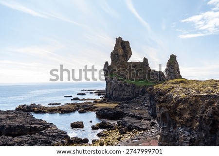 A view of the Lóndrangar basalt rock pinnacles, found on the Snaefellsnes peninsular outside the town of Hellnar, Iceland.