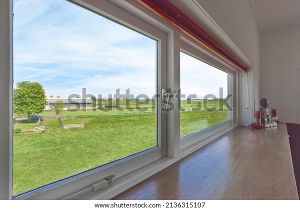 The view from the bathroom\
window is a huge field with grass. Calm atmosphere outside the\
window