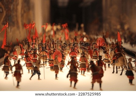 View of battle war field scene model during Japan History, asian soldiers fighting on display at Osaka Castle, selective focus