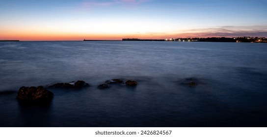 View of the bay with misty water in the evening after sunset