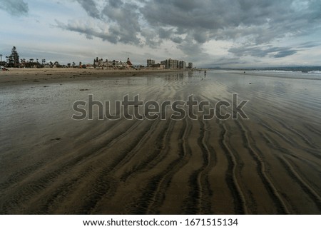 view of beach against cloudy sky