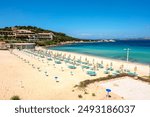 View of the beach of Baia Sardinia, a tourist resort in northern Sardinia Island, famous for the clarity of the sea waters and the beauty of the surrounding landscape.