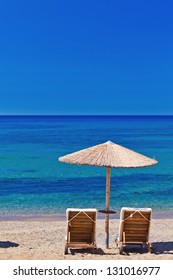 View Of The Beach With Chairs And Umbrellas. Greece.