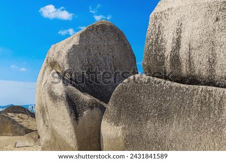 View of the beach with huge rocks. Sanya, China. Park Heavenly Grottoes.