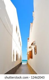 view of the beach through/between two buildings