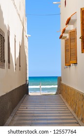 view of the beach through/between two buildings