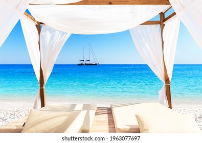 View Of A Beautiful Beach Through A Balinese Bed. Nice Tropical White Sandy Beach With Bed In Punta Cana, Dominican Republic. Vacation Holidays Summer Background. 