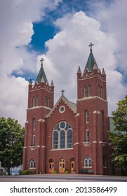 View Of Beautiful Midwestern Catholic Church With Dramatic Clouds Above 