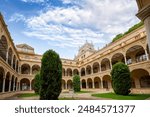 View of the beautiful Renaissance cloister of the Faculty of La Merced, University of Murcia, Spain in midday light and trees in its inner courtyard