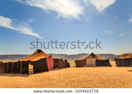 view of bedouin tent with clear blue sky above it