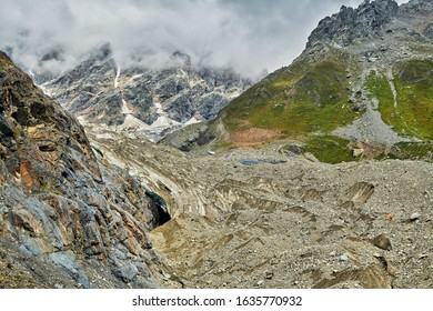 View of the beginning of the Shkhara glacier. From the left, a deep glacier crack, bergschrund is visible. The beginning of the storm. One-day tracking from Ushguli August 2019.