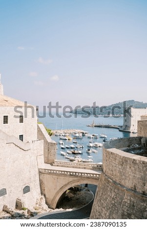 View from behind the fortress walls to the pier with moored boats. Dubrovnik, Croatia