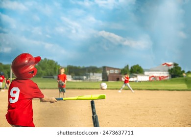 View from behind home plate with a batter swinging at a T-ball. - Powered by Shutterstock