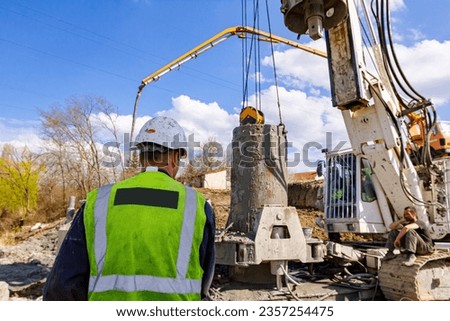 Similar – Image, Stock Photo Engineer managing cables behind solar panels at a solar farm. Alternative energy ecological concept image.
