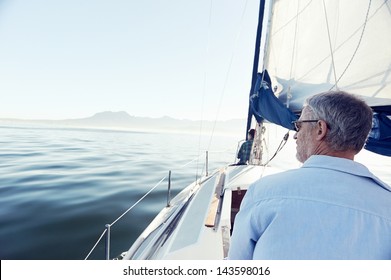view from behind of sailing man on hobby boat at sea