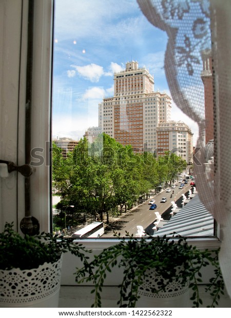 View behind a window of the Plaza de España\
and the Edificio España in Madrid,\
Spain