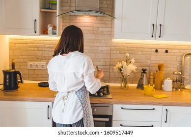 View From Behind Woman On Kitchen Cooking