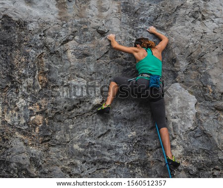 View from behind of a young  female rock climber