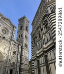 View from below the Duomo in Florence, capturing the grandeur of its intricate facade and towering dome against the sky