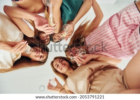 View from below. Group of happy women that is at a bachelorette party.